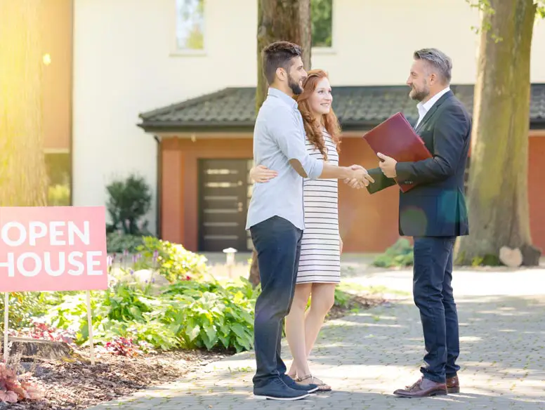 Couple with agent at an open house.