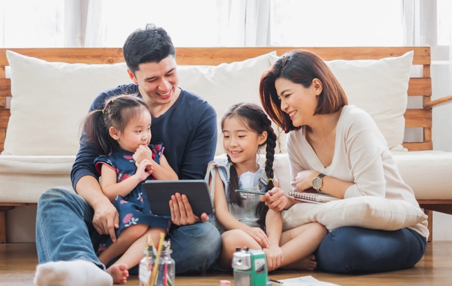 family in living room watching tablet