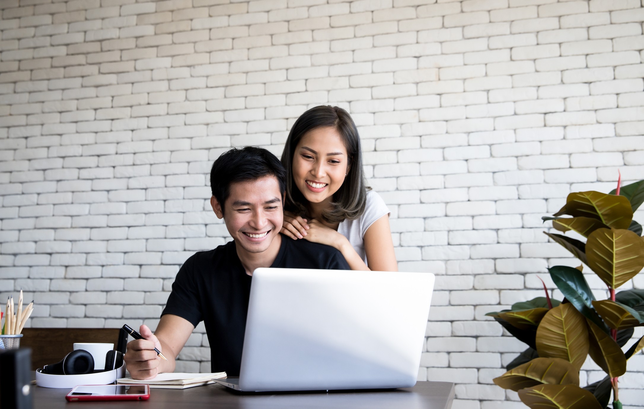 couple smiling over computer