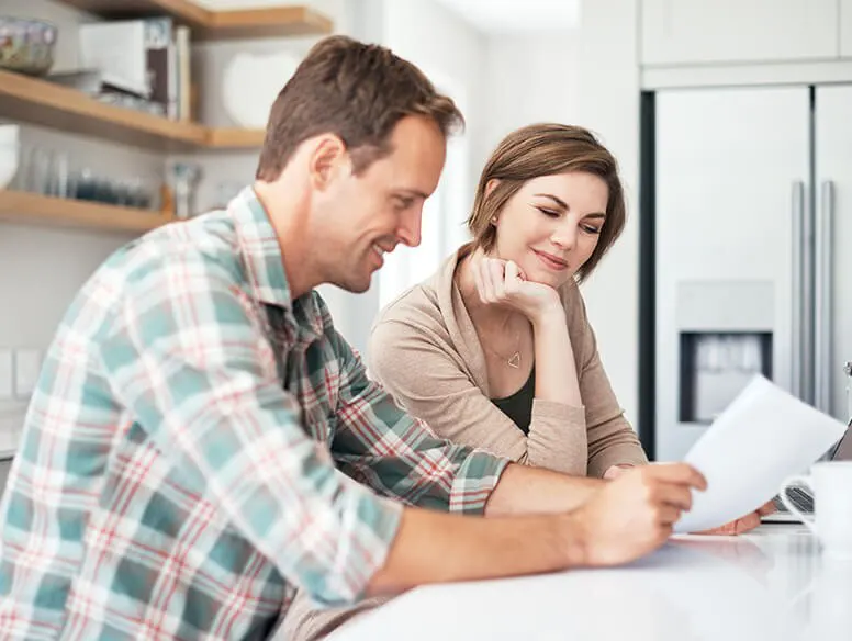 Couple looking at paperwork in kitchen