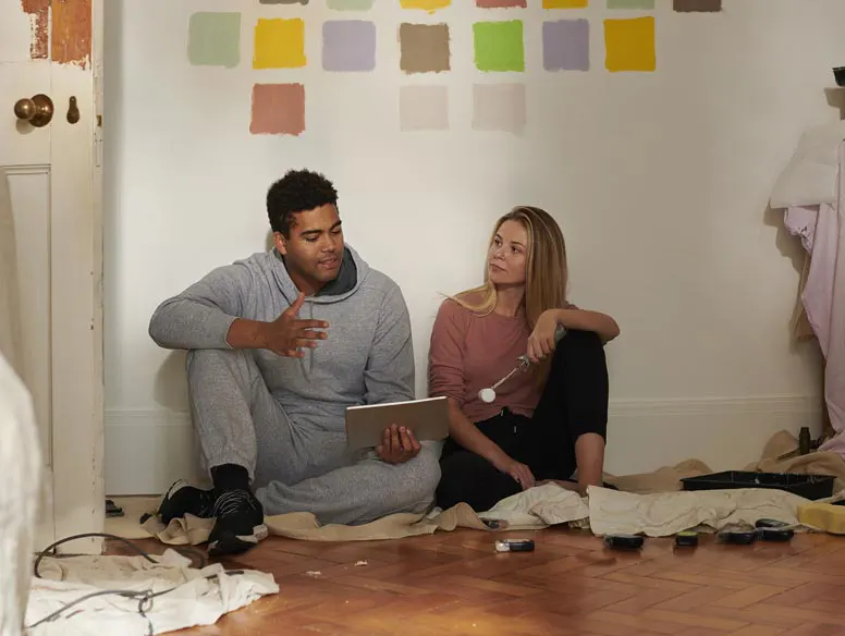 Couple looking over paint swatches while redecorating
