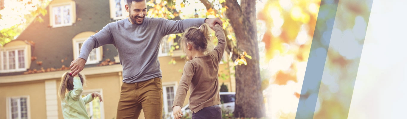 father with daughters in autumn
