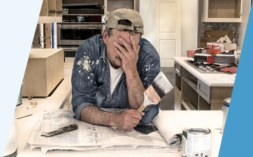 Man painting home covers face with palm