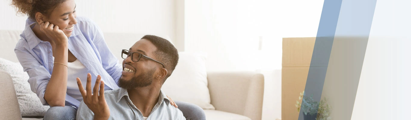 black couple moving boxes