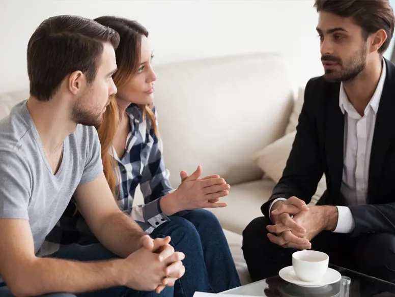 Couple meets with agent in their home