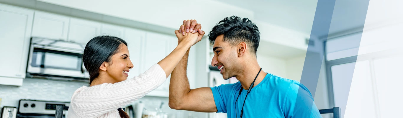 South Asian couple celebrating in kitchen