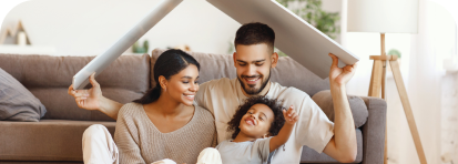 photo of family with home cardboard lifted above