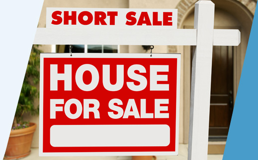 Short sale sign in front of house