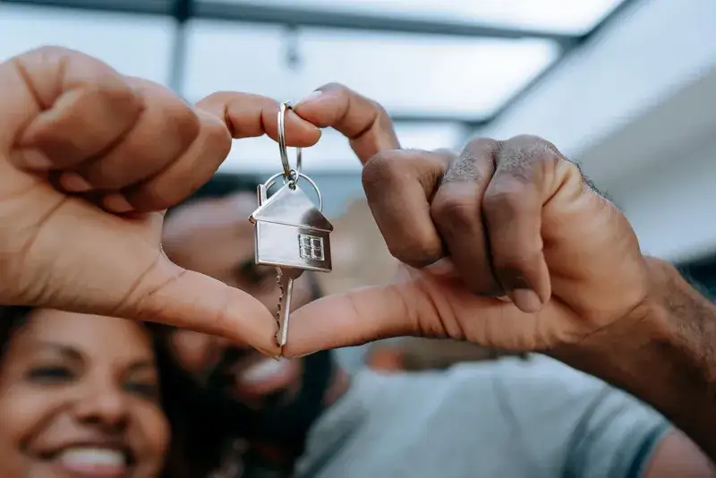 Close up image of couple holding key to new home